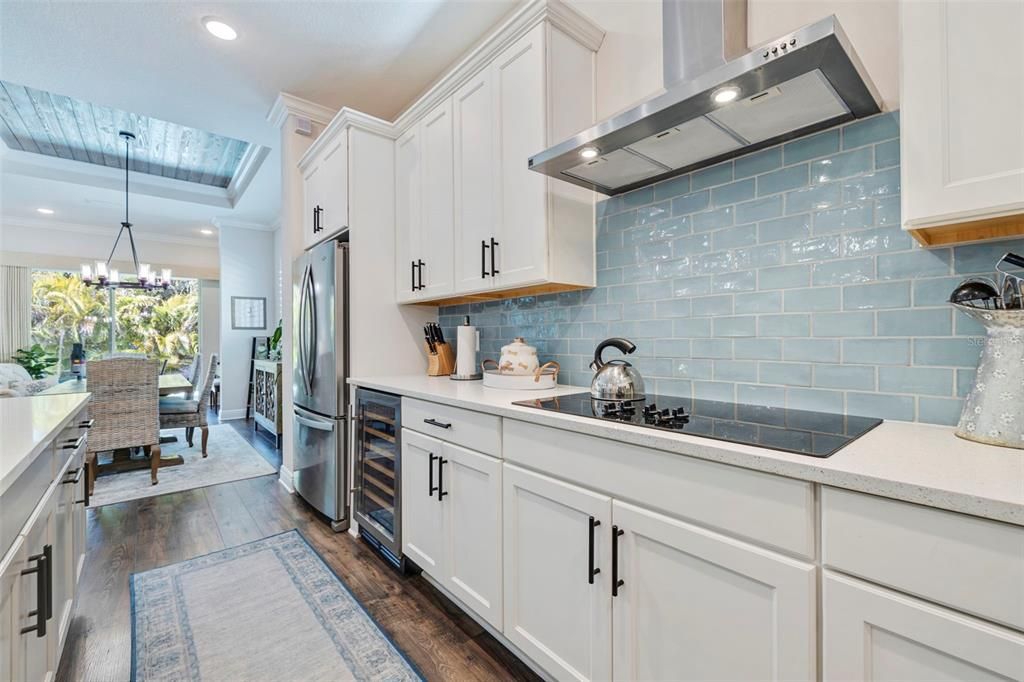 Mineral blue subway tile and contemporary hardware add a finishing touch to the shaker cabinets.