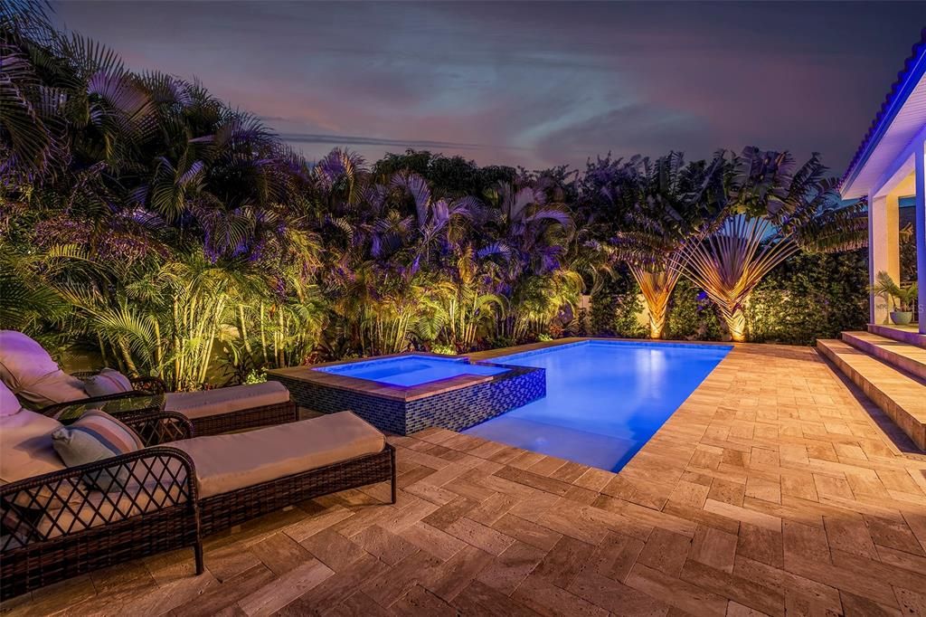 Privacy and luxury abound with a lush canopy of Areca Palms and dramatic pool and landscape lighting.