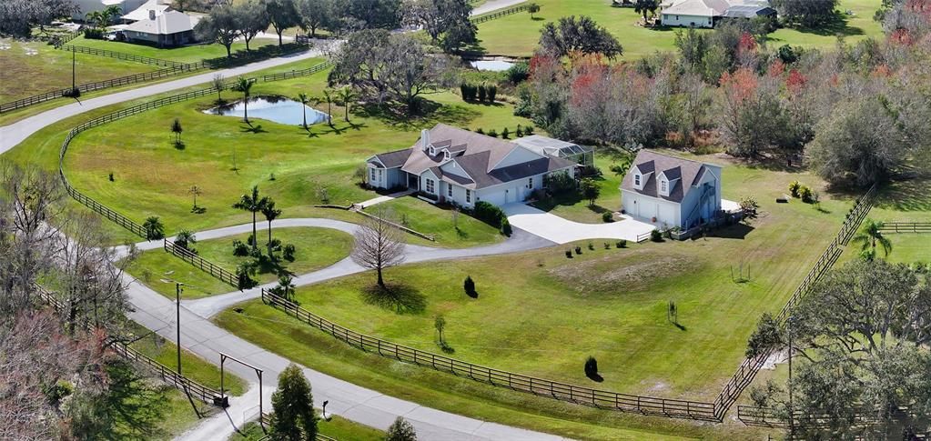 Large estate with over 5 acres, fenced in with two ponds, 4 garages and separate In Law Apartment.