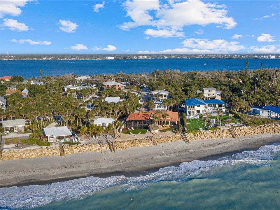 Aerial view showcasing a wide beach and riprap