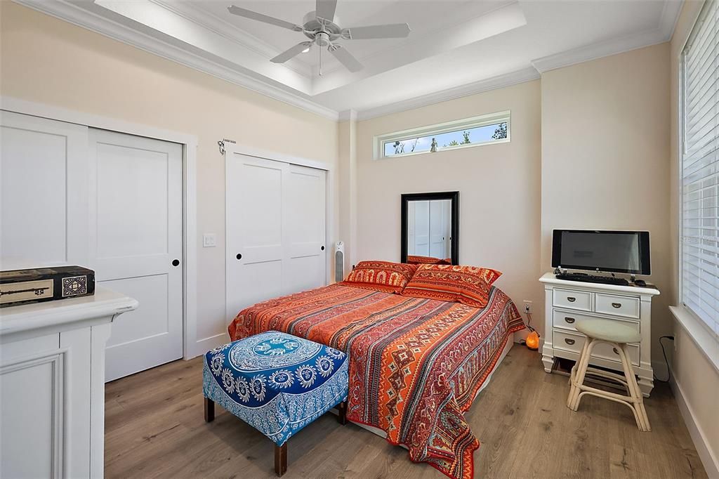 The spacious primary bedroom with tray ceiling.