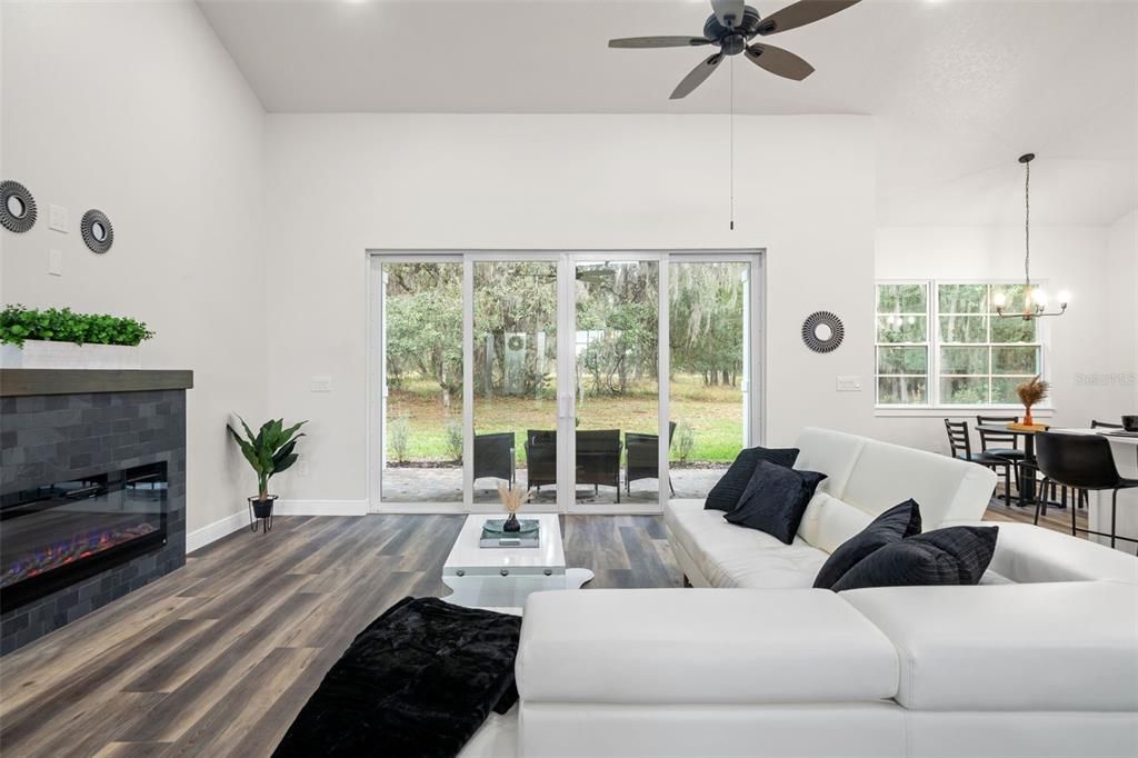 Living Room with luxury vinyl flooring and sliders to the outdoor patio