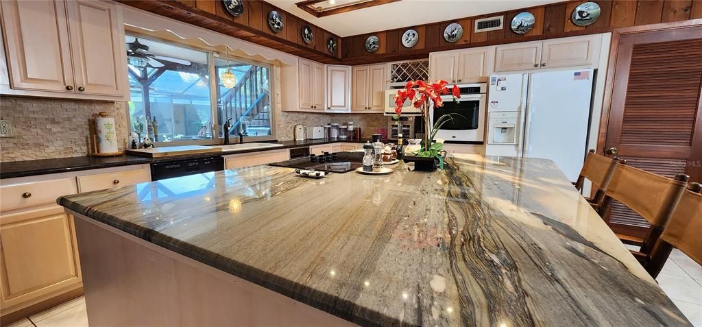 Huge kitchen with loads of cabinet and countertop space.  Enjoy the Pool & Hot Tub view from the kitchen area.