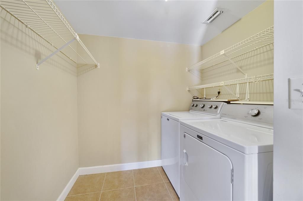 The large LAUNDRY ROOM includes built-in shelving and tile floors for easy maintenance!