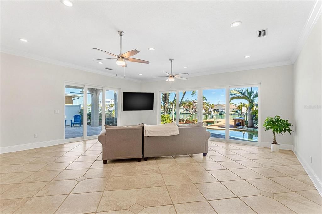 Living room with view to the patio, pool and waterfront