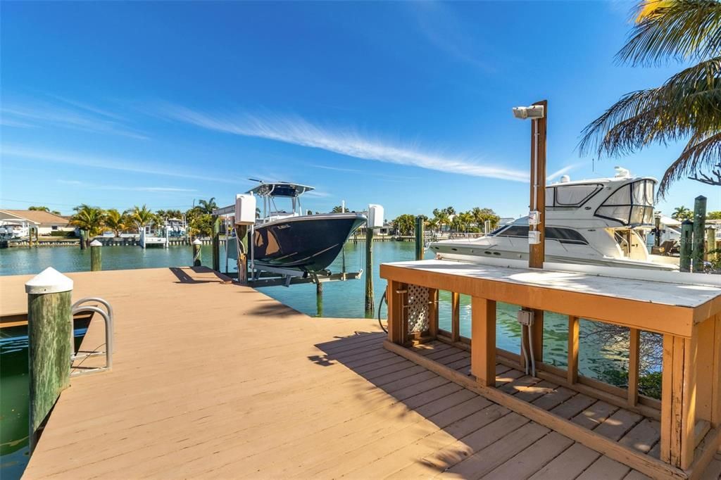 Oversized dock with boat lift and fishing station