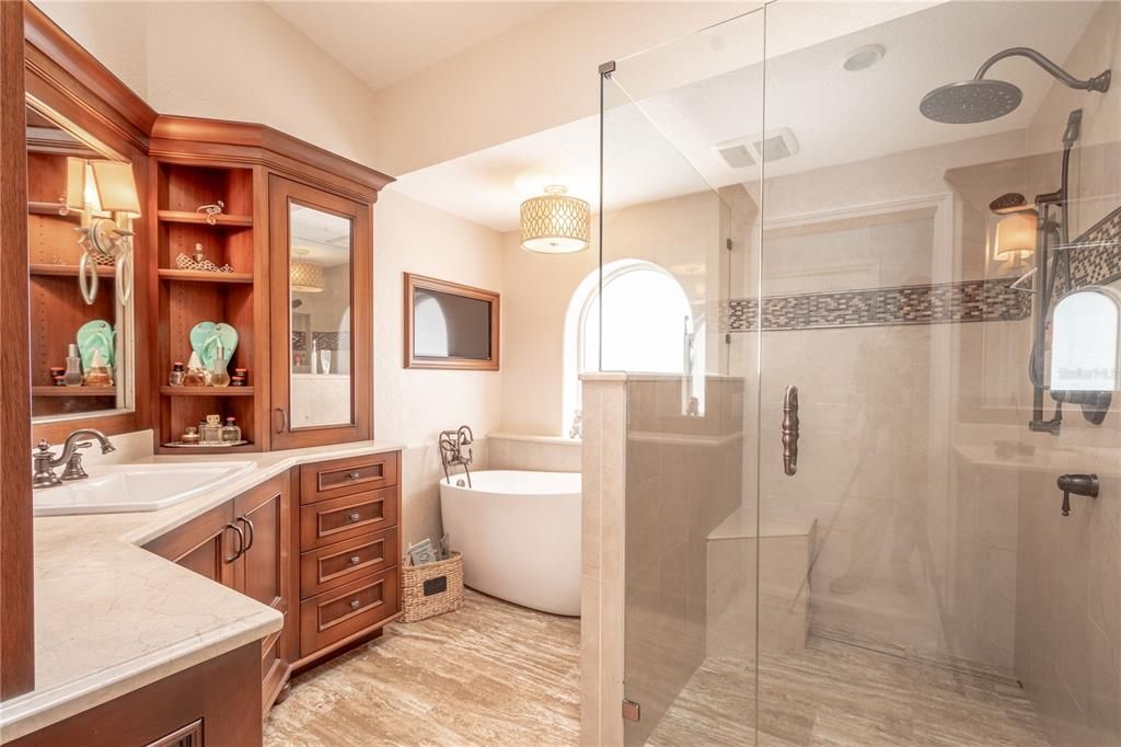 The primary bath features stylish ceramic tile flooring and decorative tile in the shower.