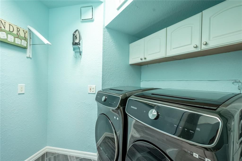 The laundry room features built in cabinets and a hook up for your washer and dryer.
