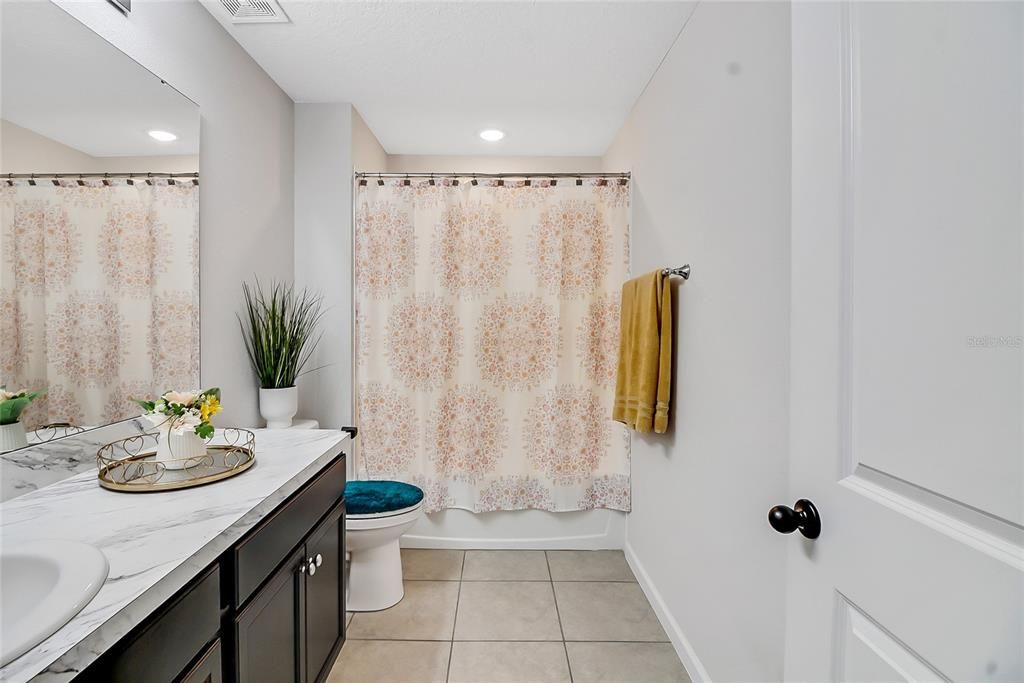 Hall Bathroom upstairs with Tub/Shower, Ceramic Tile flooring, Single Vanity with an abundance of countertop space