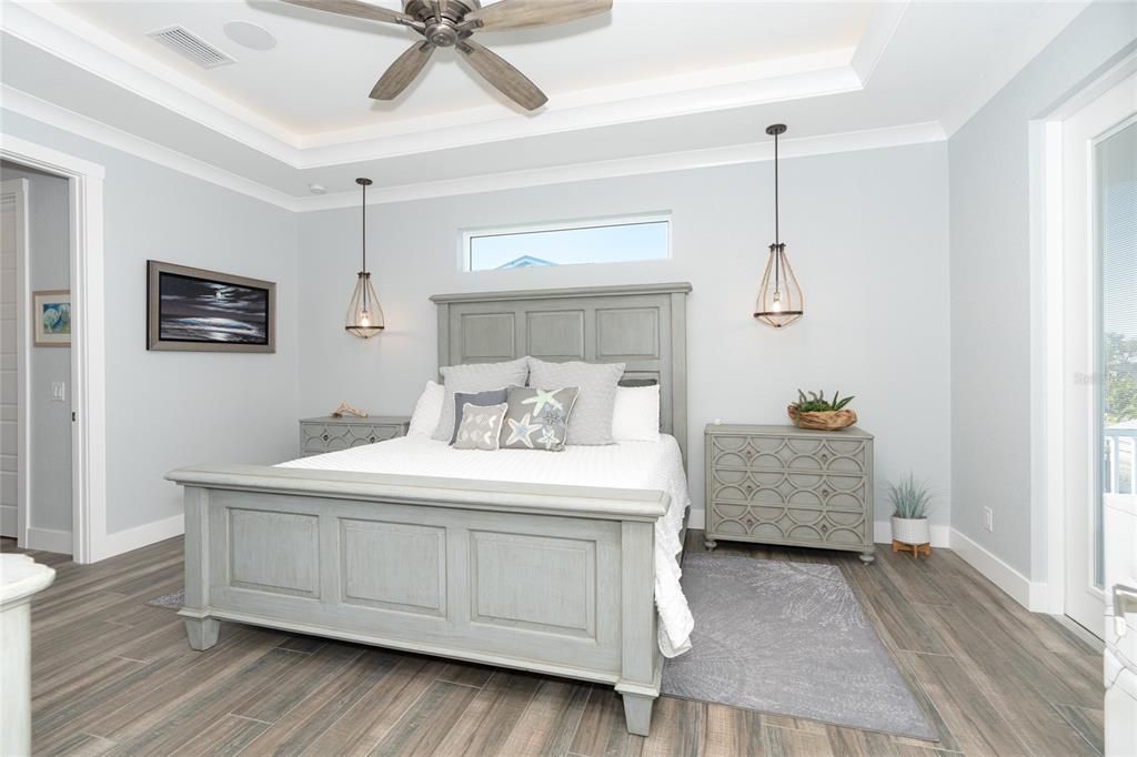 Master Suite features a tray ceiling with crown molding and accent lighting