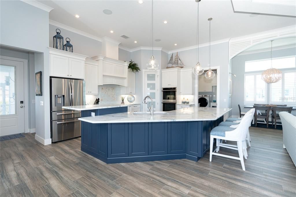 Spacious kitchen offers a pantry with wood shelving