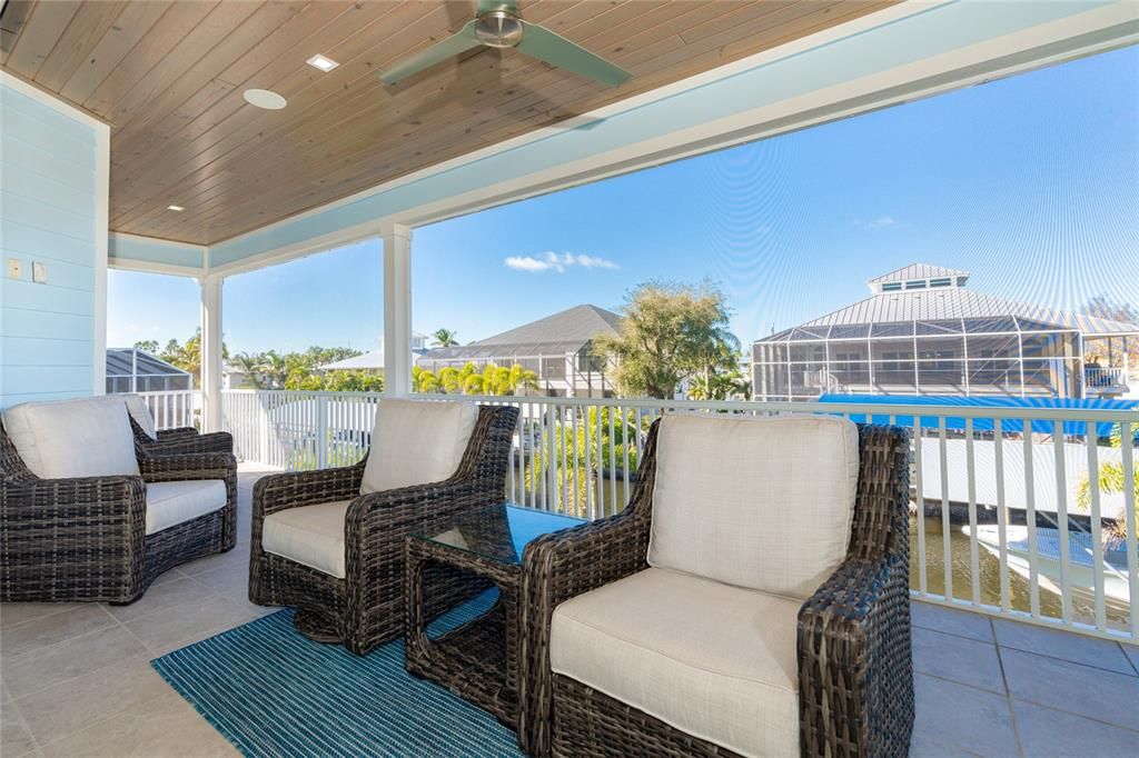 Views from the balcony overlook the pool, spa & saltwater canal