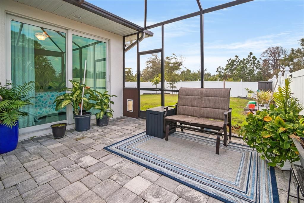 THIS AREA OF THE LANAI HAS EASY ACCESS TO A GUEST BEDROOM AND THE SIDE FENCED YARD