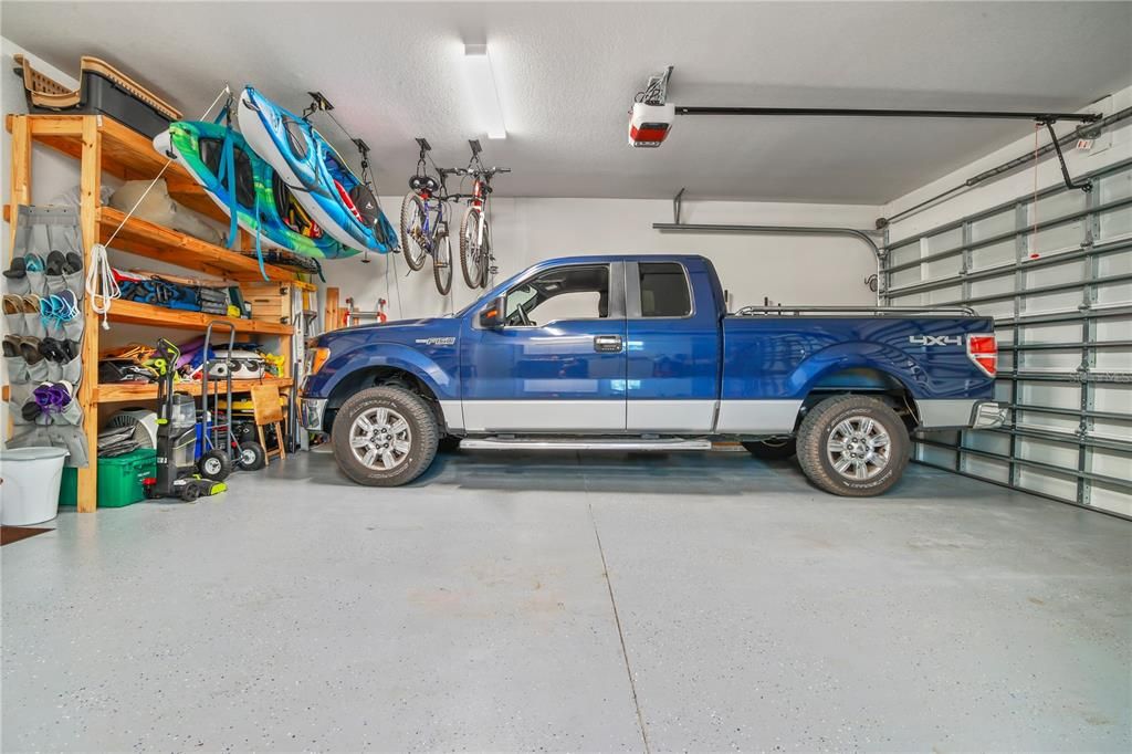 THIS OVERSIZED GARAGE HAS 9' CEILING AND PLENTY OF ROOM FOR MOST FULL VECHILES, PLUS STORAGE OF ALL YOUR PLAY TOYS