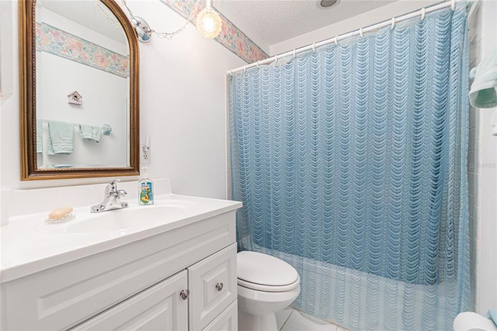 The guest bathroom has a tub/shower combo.