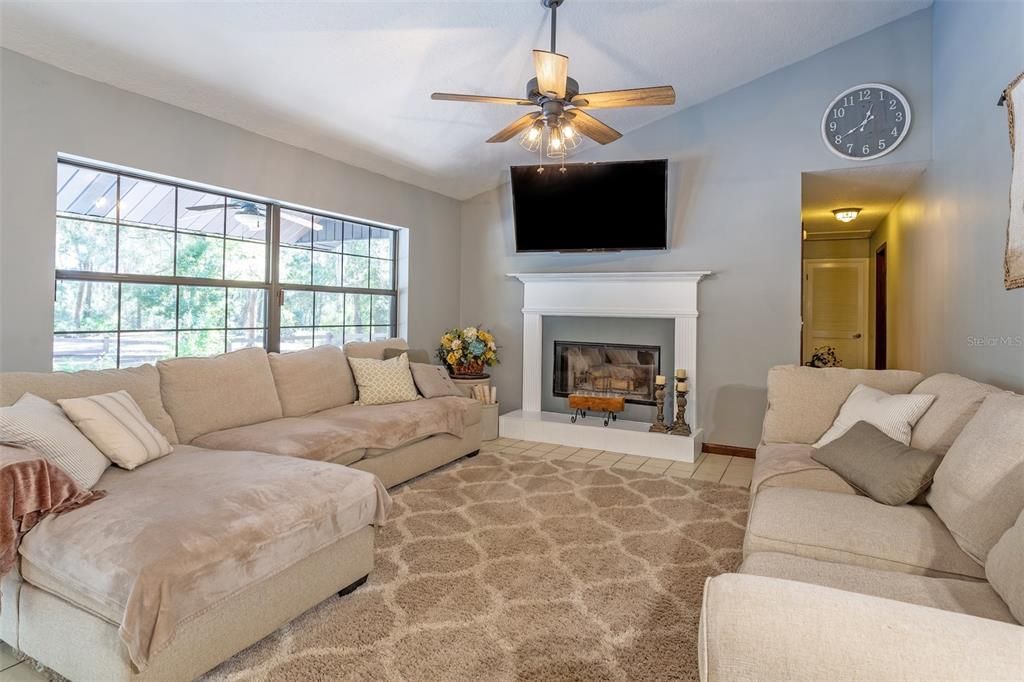 18. Family Room with fireplace, hallway leading to guest rooms and hall bath