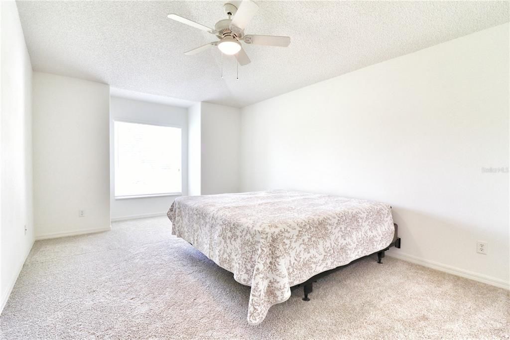 master suite with vaulted ceiling