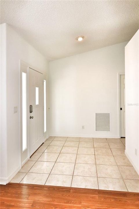 tile entry foyer with coat closet