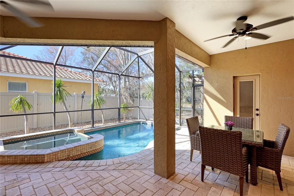 view from Great Room out to Lanai, seating area, pool bath and Saltwater pool and Spa.