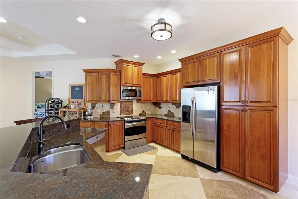 Beautiful Kitchen with custom cabinetry, abundance of storage and stainless steel appliances.