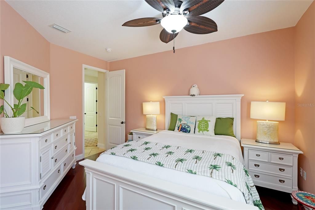 Split floor plan finds Bedroom 2 with ceiling fan, wood floors and large built in closet.