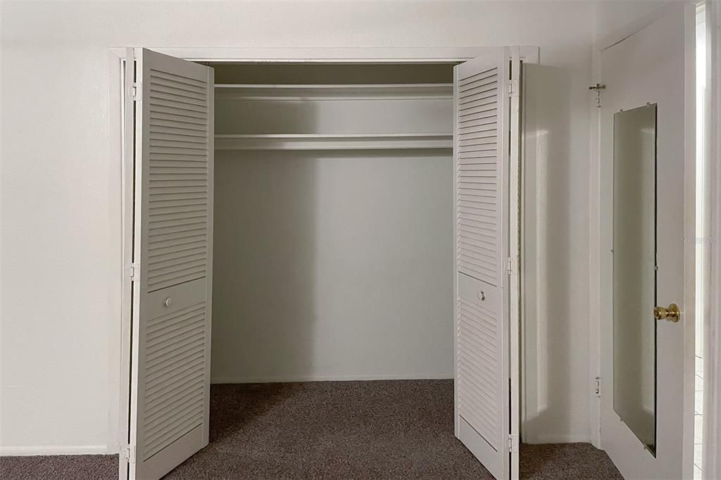 Open closet door in Bedroom 2 of Unit 1