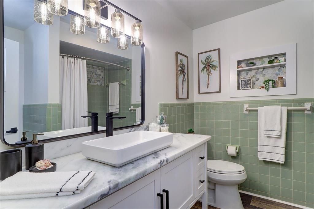 Retro green tile and tub is the highlight that enhances the newly renovated bathroom ?? in Unit 2