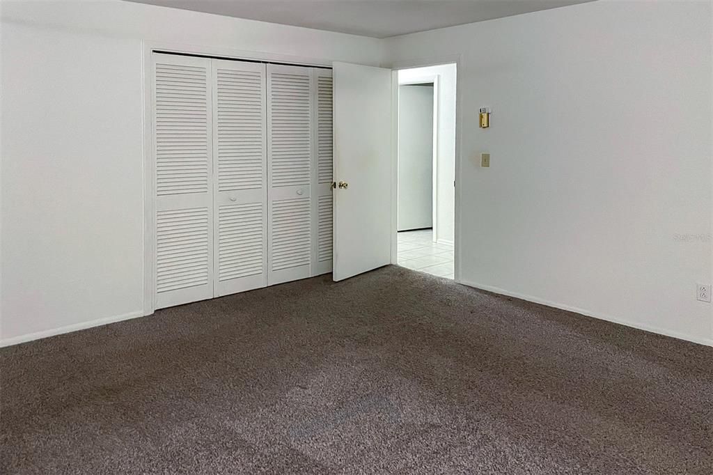 Bedroom door of hallway and view of closet location in Unit 1