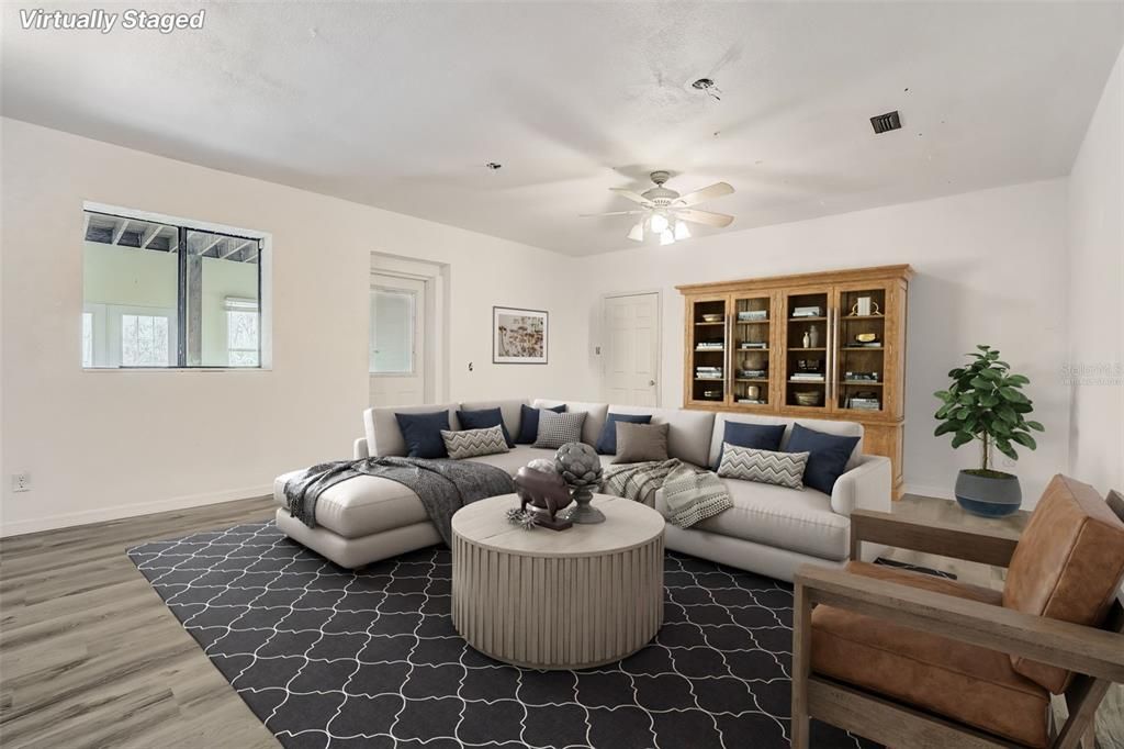 Virtually staged downstairs family room with door leading out to the second bonus room