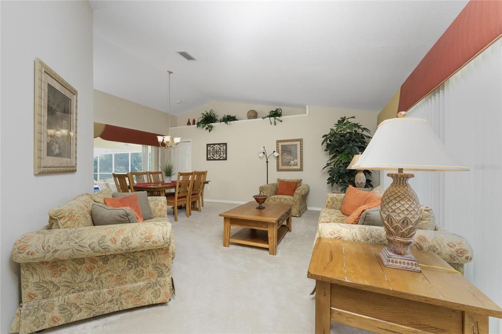 The great room layout and cathedral ceiling enhances the large living room and dining room space.