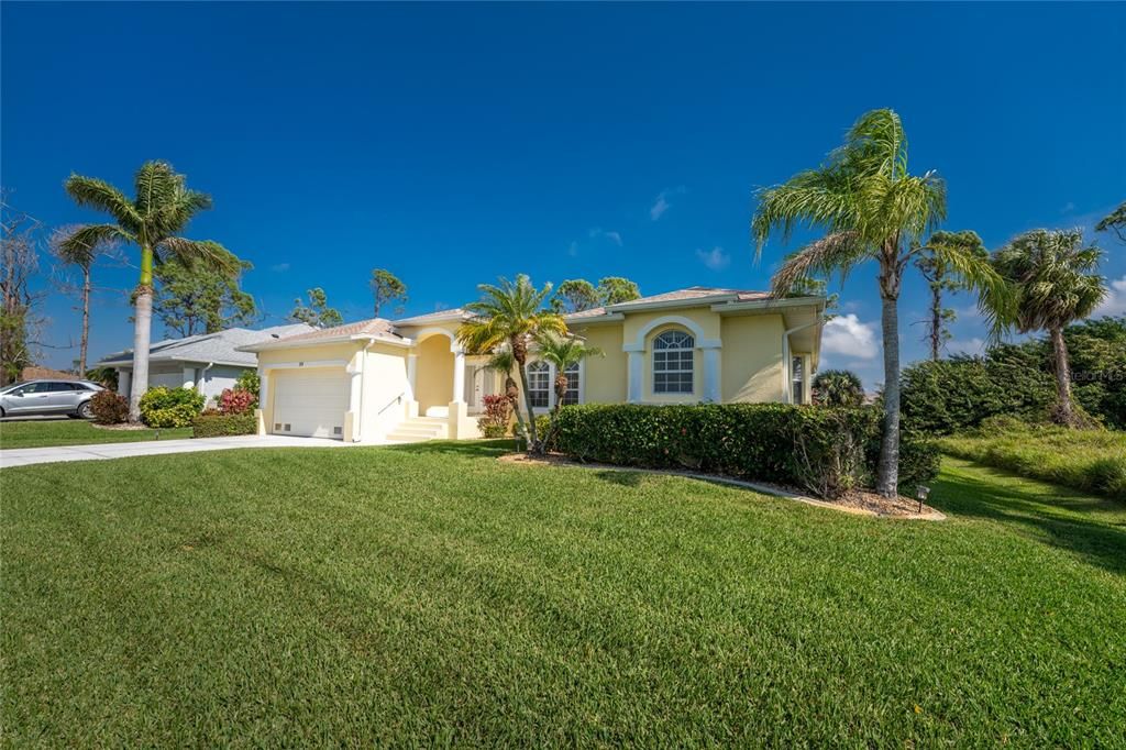 This spacious home is complimented by lush, tropical landscaping.