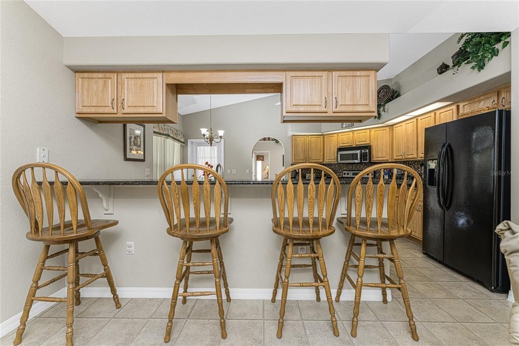 The kitchen breakfast bar is open to the family room and is long enough for 4 bar stools.