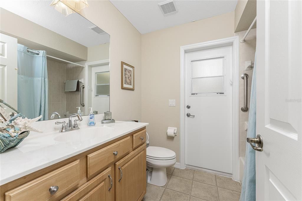 Enjoy direct access to the pool area from the guest bathroom. It has a tub/shower combo.