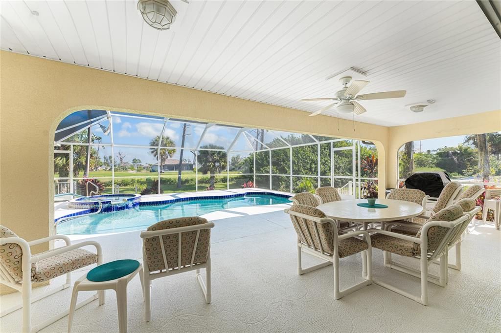 The covered part of the pool deck is spacious enough for lots of seating, vinyl lined ceiling, a ceiling fan and lighting.