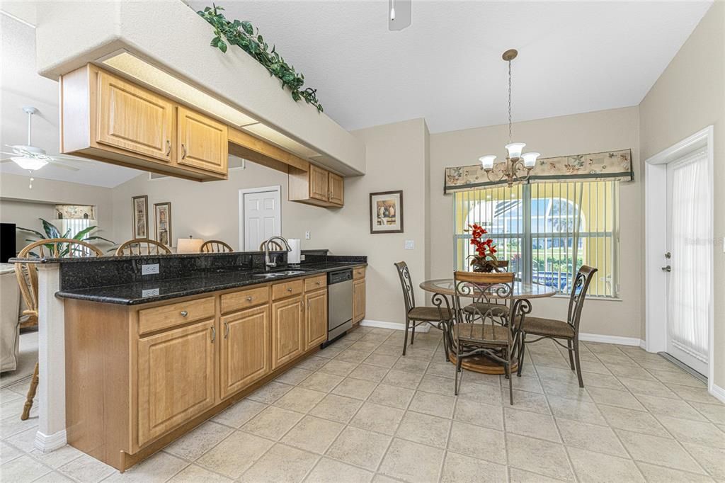 The kitchen has an eat in area with plenty of room for a dinette table, and has a chandelier.