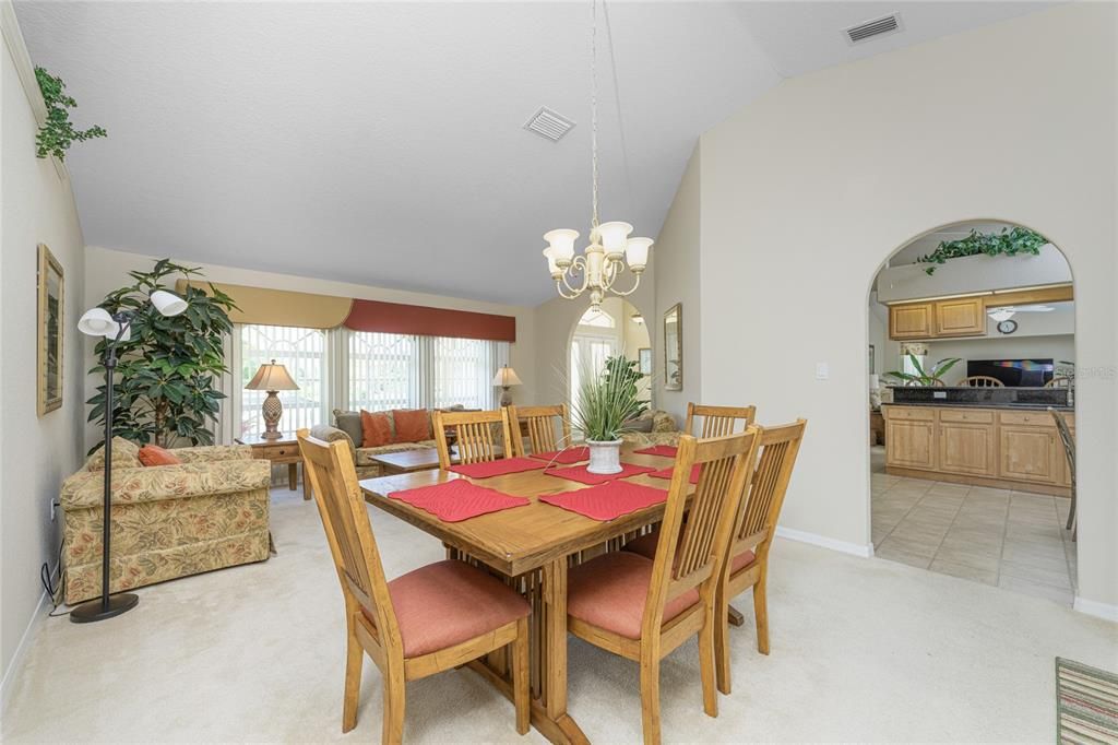 The built in plant shelf and arched walkway to the kitchen from the dining room add architectural detail.