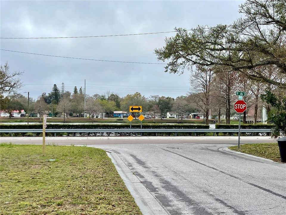 View down the street from lot with partial view of lake/fountain