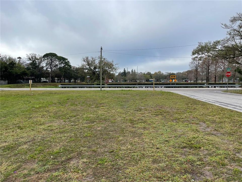 View down the street from lot with partial view of lake/fountain