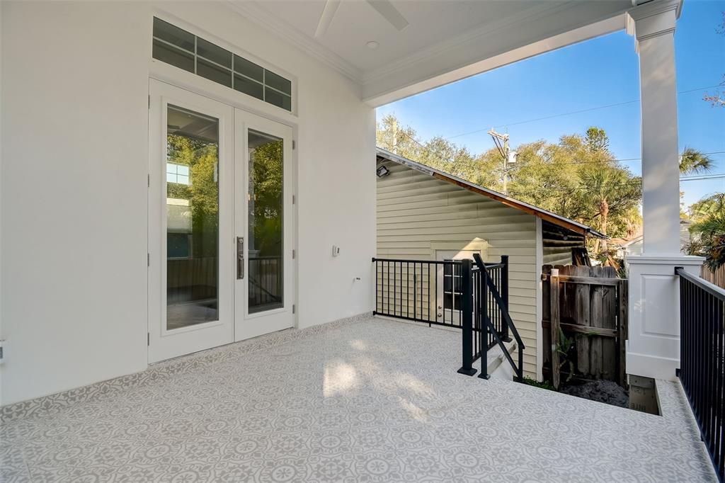 French Doors in Master Suite open the Back patio, Garage shown in background to be painted white.