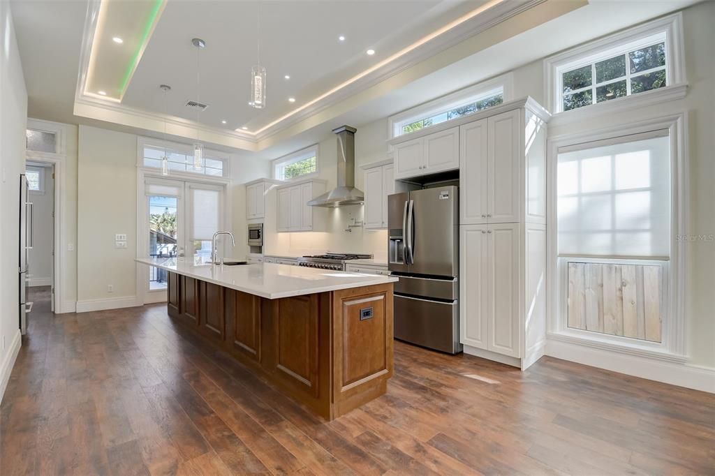 Open Kitchen has a Fabulous Island and French Doors opening to a large back patio!!