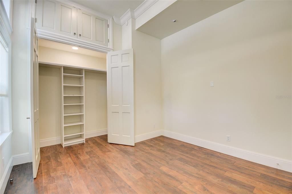 2nd Bedroom has a spacious closet with custom built-ins and extra storage above!