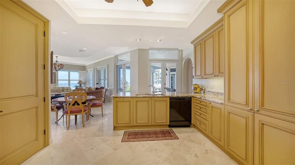 Big open kitchen, beautiful cabinets and travertine floors