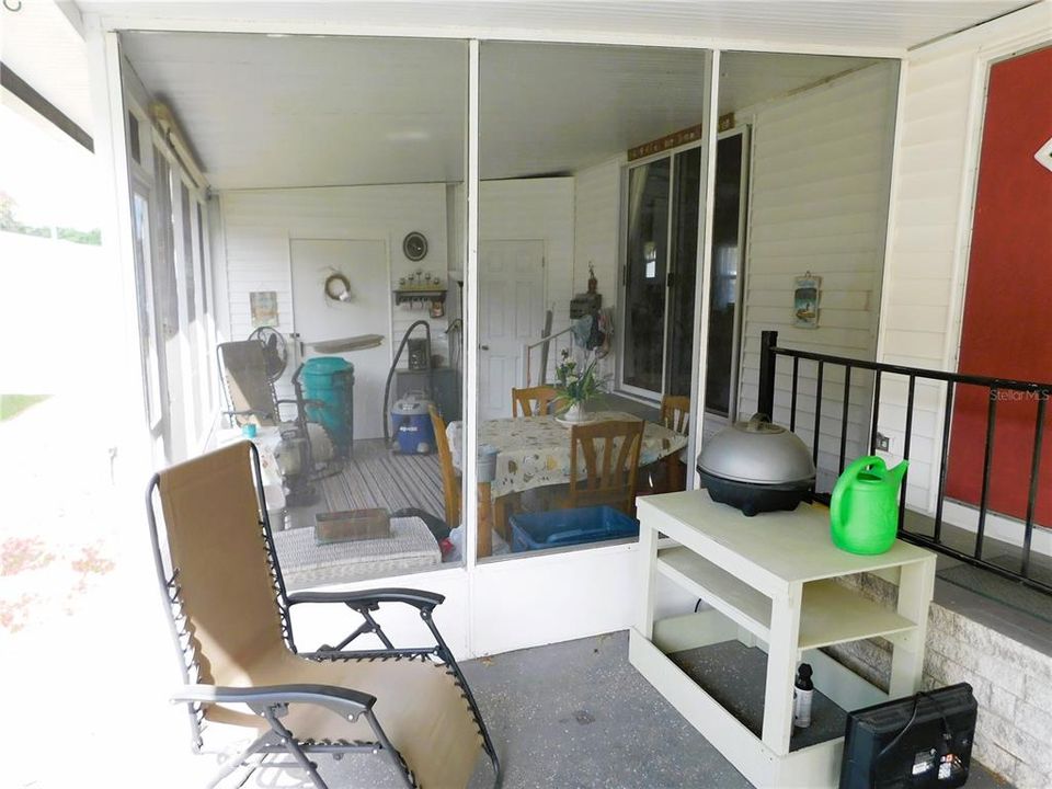 Screen room off carport.