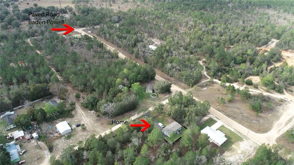 Aerial view paved road & property marked w/ arrows