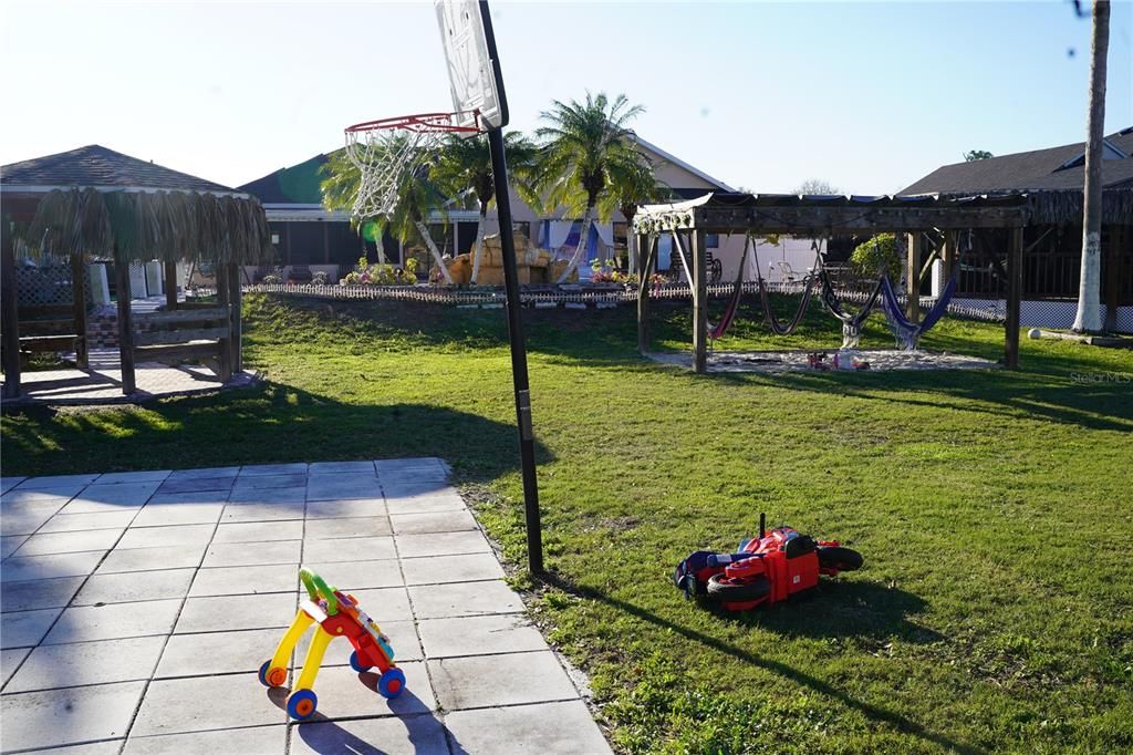 looking from the  basketball court towards the pool and rear of the house area