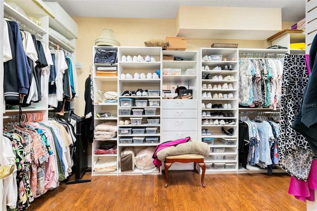 A vast walk-in closet boasts built-ins for storage.