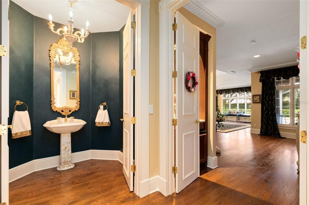 A washroom with a pedetal sink is just outside the master suite.