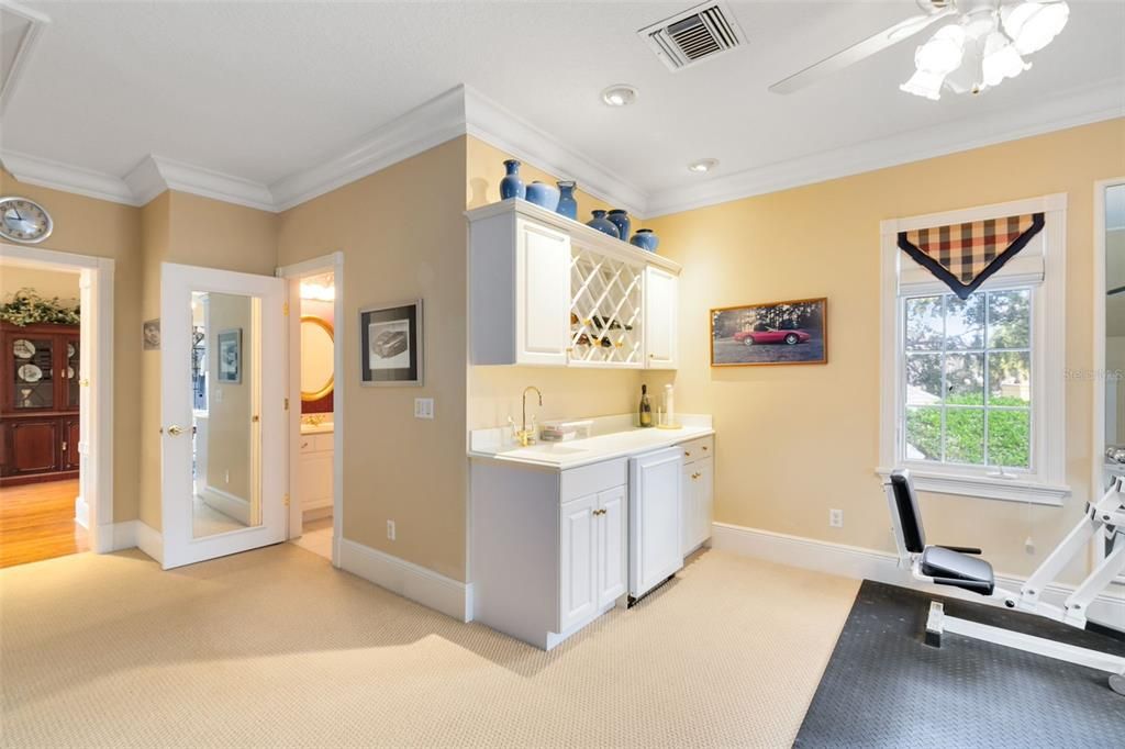 A wet bar here is ideal for snacks and drinks while watching movies or to rehydrate after working out.