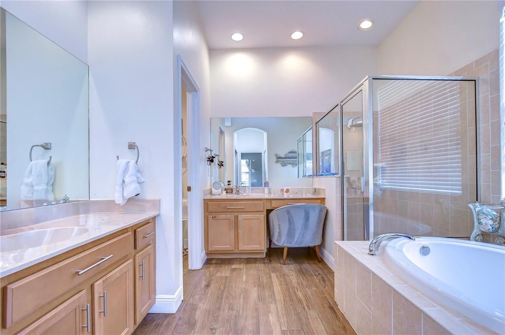 En-suite bath with a large shower, garden tub, separate vanities, and walk-in closet!