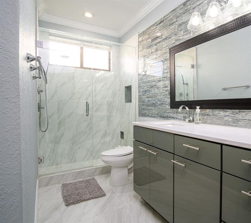 3rd bathroom with step in shower, quartz countertops, custom vanity
